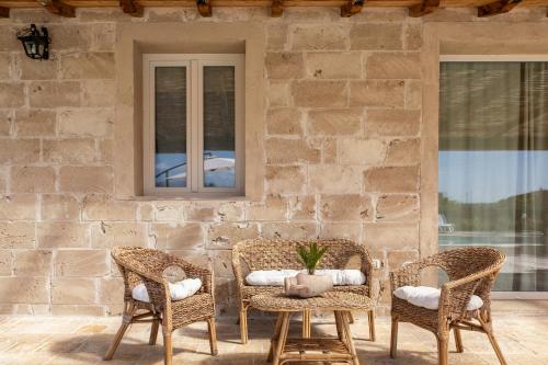 卡潘诺里Casa Brigante Luxury with Pool的庭院配有2把藤椅和桌子