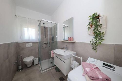 扎达尔Apartment Fiorino的一间带水槽、淋浴和卫生间的浴室