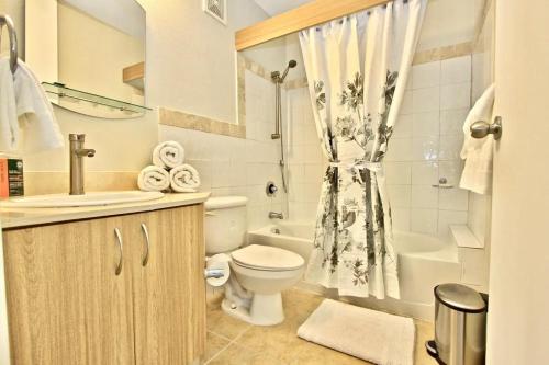 法哈多Ocean & Marina Views 3 Bedroom 2 Bathroom Luxury Condo的浴室配有卫生间、盥洗盆和淋浴。