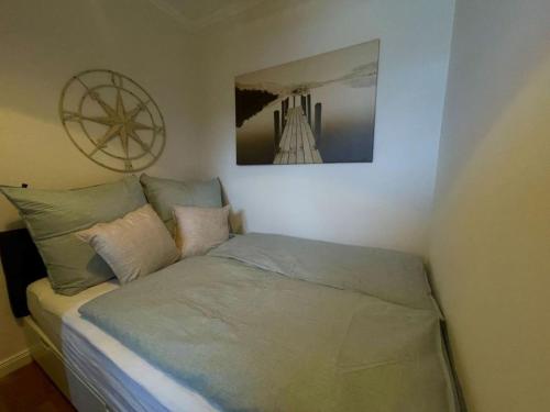 格洛米茨Sandliebe的卧室内的一张床铺,墙上挂着一幅画