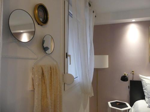 布拉尼亚克Studio climatisé Le Marilyn - Dormiratoulouse Blagnac的卧室配有镜子和挂在墙上的连衣裙