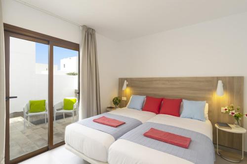 普拉亚布兰卡Villa Matilde by Villa Plus的卧室配有带红色枕头的大型白色床