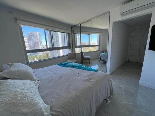 埃斯特角城Miami Boulevard II excelente, a 100 metros del mar的一间卧室设有一张大床和大窗户