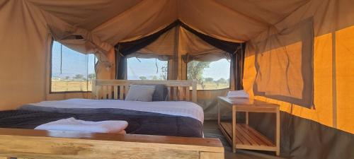 Kisarukabwoya Safari camp Kaiso village的帐篷内一间卧室,配有一张床