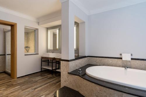 约翰内斯堡普罗提流浪者酒店的一间带大浴缸和两个盥洗盆的浴室