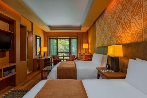 乌鲁班巴Tambo del Inka, a Luxury Collection Resort & Spa, Valle Sagrado的酒店客房设有两张床和电视。