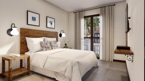 皮雷诺波利斯Eco Resort Quinta Santa Bárbara的白色的卧室设有一张大床和一个窗户