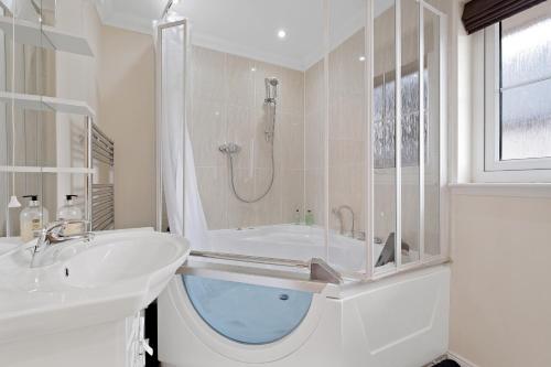 因弗内斯Taigh d'Luxe的白色的浴室设有浴缸和水槽。