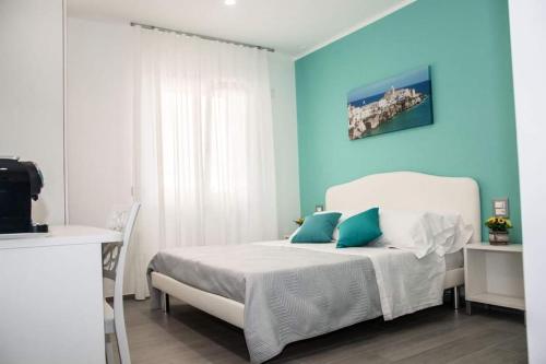 维耶斯泰Donna Marianna的卧室配有白色的床和蓝色的墙壁