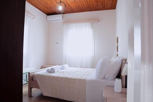 斯达林The Homey的一间卧室配有一张带白色床单的床和一扇窗户。