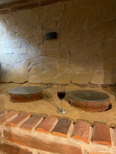 库塔伊西CHOGO的一杯葡萄酒坐在石墙旁