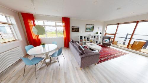海德利桑德Gotuhus - Sea View Apartment的客厅配有桌椅和沙发