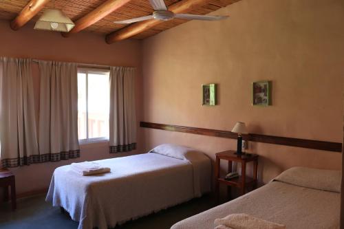蒂尔卡拉Hotel Punta Corral的酒店客房设有两张床和窗户。