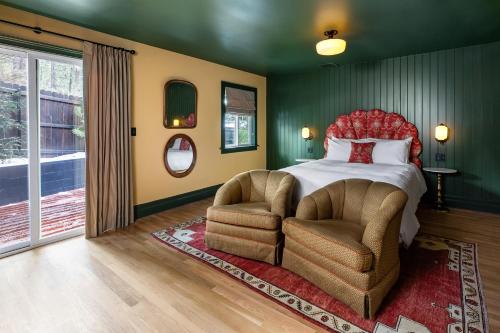 大熊湖NP Boutique Lodge的一间卧室配有一张床和两把椅子