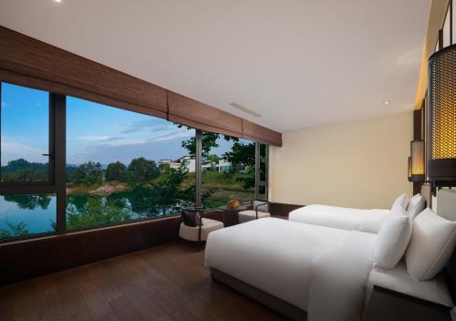 淳安千岛湖安岚酒店的卧室设有白色的床和大窗户