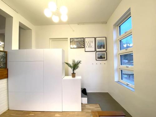 哥德堡Apartment Aekta Studio 3 Gothenburg的白色的白色房间,白色的橱柜上放着植物