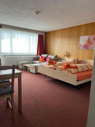 洛伊克巴德Haus Atlantic Leukerbad的一间卧室配有一张大床和一张沙发