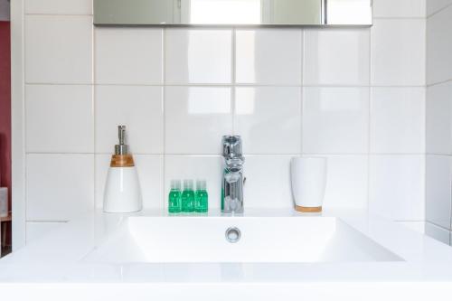 克莱蒙费朗L'adorable Confort & Central的白色瓷砖厨房内的白色水槽