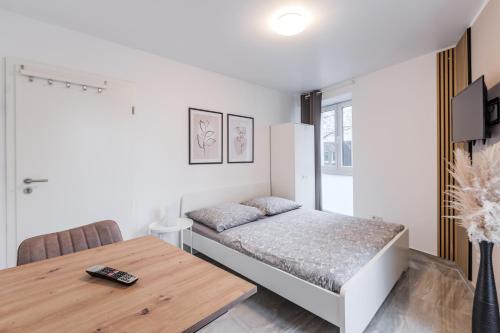 科隆Apartments Cologne的一间卧室配有一张床和一张木桌