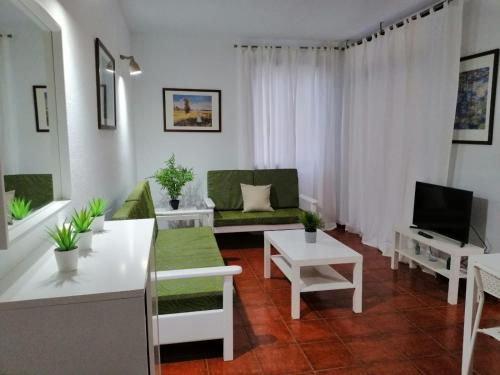 圣地亚哥海滩Casa Alisios的客厅配有沙发和桌子