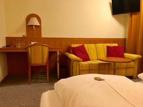 乌尔姆恩格尔酒店的酒店客房带一张床、一张桌子和椅子