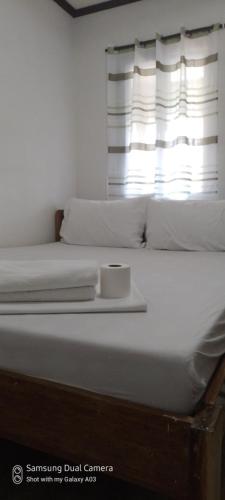 圣维森特Dhadas place的一张白色的床,上面有盘子