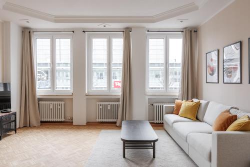 杜伊斯堡Flats 4 You, Moderne City Wohnung Nähe HBF, DÜ-Messe 20 Min, Netflix, Küche的客厅配有白色的沙发和窗户。