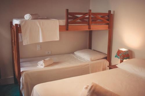 普拉杜Pousada Hannah的一间卧室配有两张双层床和毛巾