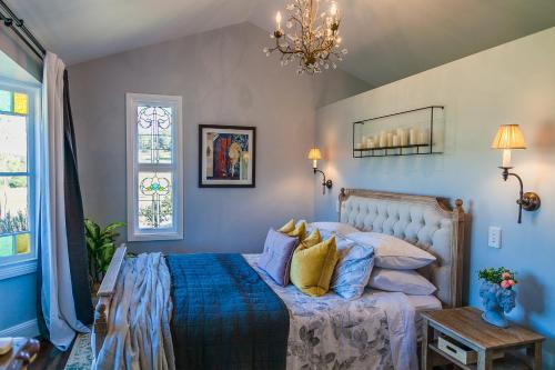 沃洛比Wollombi Wines的一间卧室配有一张带蓝色床单和黄色枕头的床。