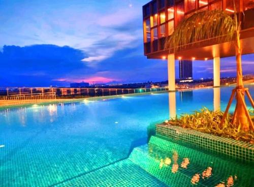 马六甲JRv HotelStyle HomeStay Melaka的夜间大型游泳池