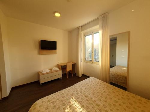 韦尔巴尼亚Casa Immacolata的酒店客房设有两张床和窗户。