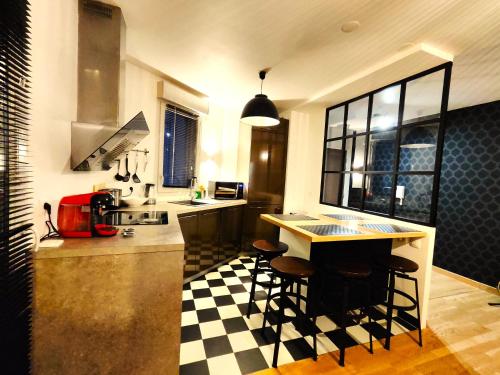 安纳马斯TROIS PIECES DE CHARME AUX PORTES DE GENEVE的厨房铺有黑白的格子地板。