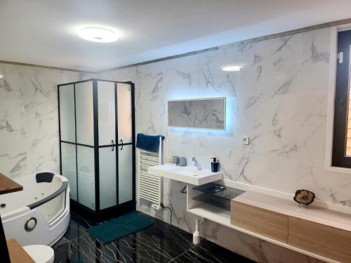 诺伊斯·勒·格兰德chambres privées dans maison bord de marne proche Disney et Paris的浴室配有盥洗盆、卫生间和浴缸。