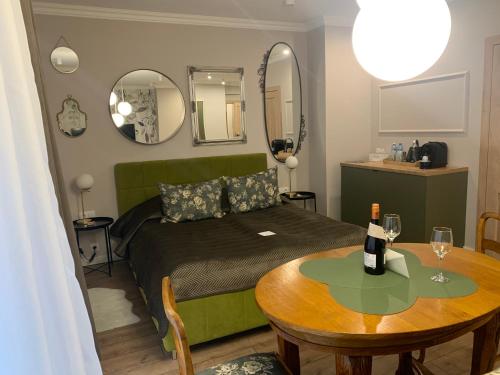 罗兹Piotrkowska 89 Apartments & Suites的一间卧室配有一张床、一张桌子和镜子