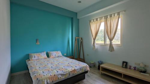 礁溪田中小琳 的蓝色的卧室设有床和窗户