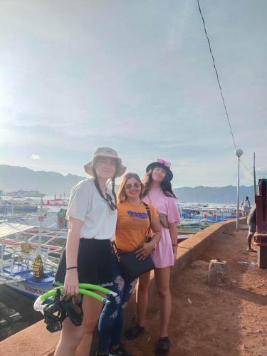 科隆SUN'S TRAVEL AND TOURS AGENCY CORON PALAWAN的三个女人在码头上拍照