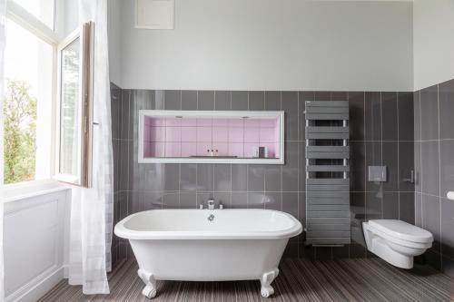SémussacChateau de Didonne的浴室配有白色浴缸和卫生间。