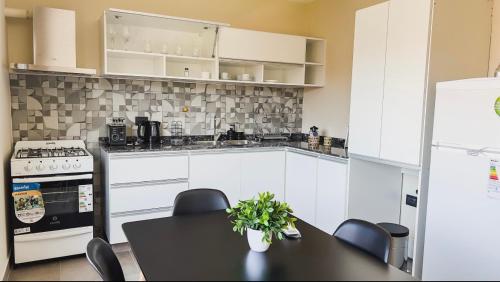 卡塔马卡Departamentos Rosina 1的厨房配有桌椅和冰箱。