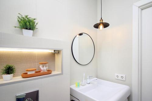 阿拉木图уютная квартира-студия в центре Алматы的一间带水槽和镜子的浴室