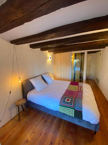 南达Chambre sur terrasse的一间卧室设有一张大床,铺有木地板