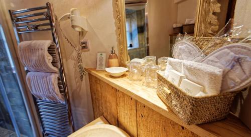 利克维Remparts de Riquewihr - Le Petit Loup的浴室的柜台设有水槽和镜子