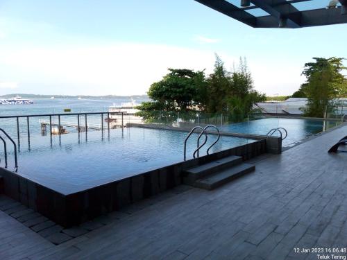 巴淡岛中心Grezia at residence的水滨带长凳的游泳池