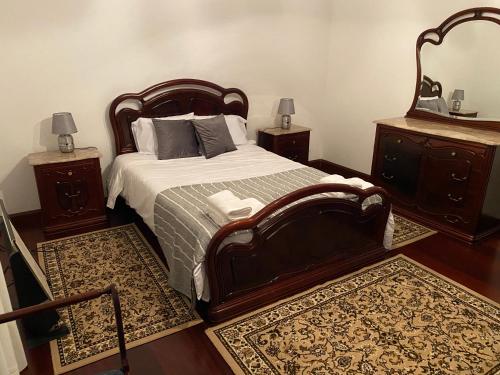 蓬塔德尔加达Green Tropical House的一间卧室设有一张大床和两个床头柜