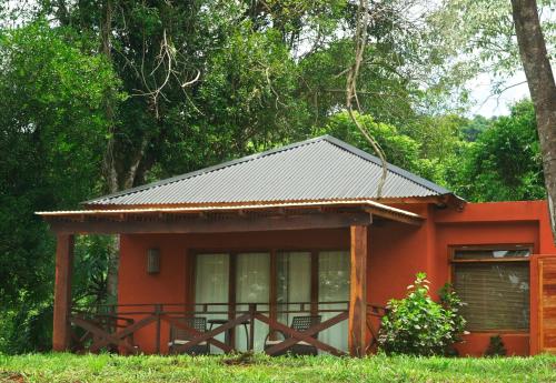 萨尔多斯德莫克纳拉米西翁摩可拿酒店 - 丛林小屋的一座带金属屋顶的橙色小房子