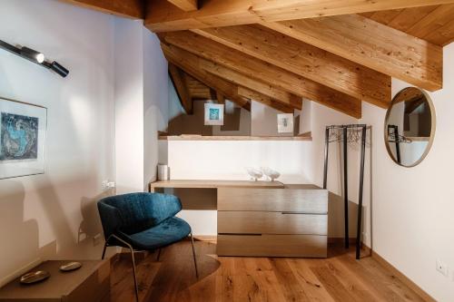 梅纳焦Il Castello - by MyHomeInComo的木制天花板的客房内配有一张桌子和一把椅子