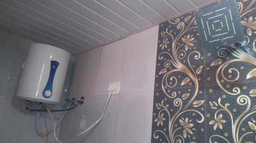 KoynanagarVinee's Kitchen and Motel的墙上带吹风机的浴室
