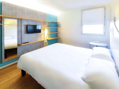 第戎第戎市中心克莱蒙梭宜必思快捷酒店的卧室配有一张白色大床和电视。