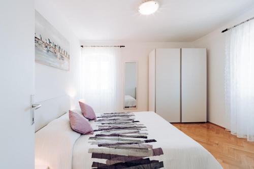 韦利拉特萨卡伦旅馆的卧室配有带毯子的白色床