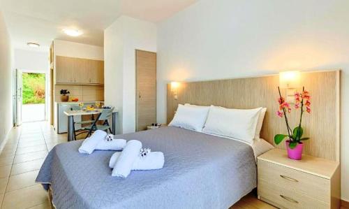福德勒Fodele Beachfront Apts, Βy IdealStay Experience的一间卧室配有一张大床和毛巾