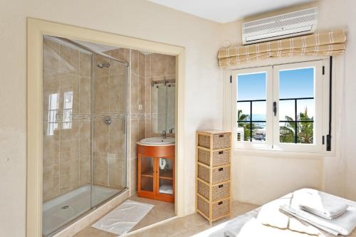 马贝拉J96 Cabopino的带淋浴和盥洗盆的浴室